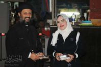 كاهن  وسيدة مسلمة يوزعان حلوى المولد النبوى ببورسعيد