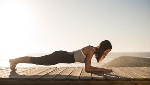 women doing pilates on the beach